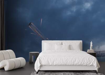 Stunt Plane shooting fireworks in the clouds Wall mural