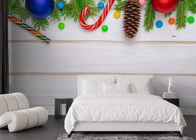 Christmas back,ground, green fir branches, red and blue, yellow, ball, candies, cone, white boards Wall mural