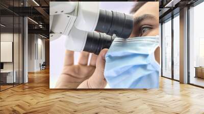 Doctor using a dental microscope Wall mural