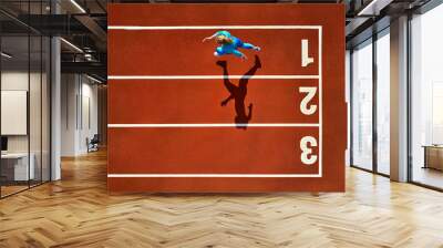 Sportive blonde woman running at open stadium Wall mural