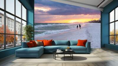 Colorful pastel sunset in Santa Rosa Beach with Pensacola coast in Florida Panhandle at Gulf of Mexico ocean waves with silhouette of people Wall mural