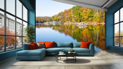 Great Falls in Maryland with yellow orange colorful autumn foliage leaves on trees with reflection in water surface of river canal or lake Wall mural