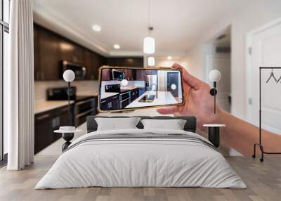 Hand photographing house apartment kitchen island room for sale or rent with phone smartphone closeup point of view in modern luxury condo home with blurry bokeh background Wall mural