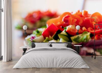 Healthy vegan vegetarian lunch or dinner green vegetables red bell pepper salad with nobody and two plates in bokeh background Wall mural