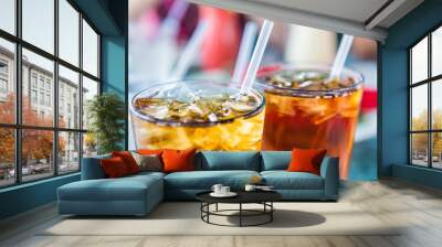 Macro closeup of iced tea or soda with ice cubes and straw in glass Wall mural