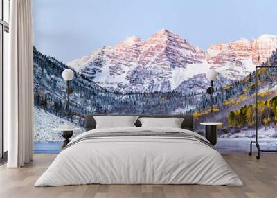 Maroon Bells morning sunrise with sunlight on peak in Aspen, Colorado rocky mountain and autumn yellow foliage view closeup and winter snow frozen lake Wall mural