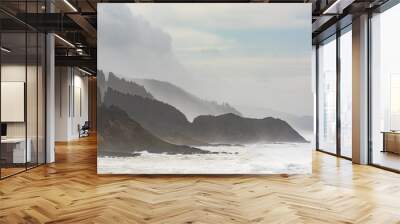 Misty and Foggy Oregon Coast cliffs and forests with stormy sky and ocean waves Wall mural