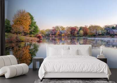 Sunrise on Braddock lake in Burke, Virginia, USA with reflection in autumn and orange tree Wall mural