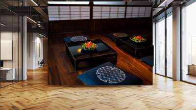 Traditional japanese house or ryokan restaurant room with two salad plates on table, cushion pillows with shoji sliding paper doors in background Wall mural