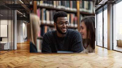 Diverse group of young people chatting in college library  Wall mural