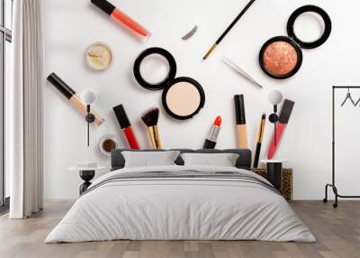 Leather make up bag, with cosmetic beauty products spilling out on white background Wall mural