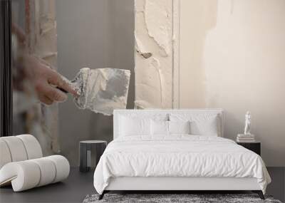 Builder using a trowel to add plaster. Plastering wall with putty-knife, close up image. Fixing wall surface and preparation for painting. construction work during quarantine Wall mural