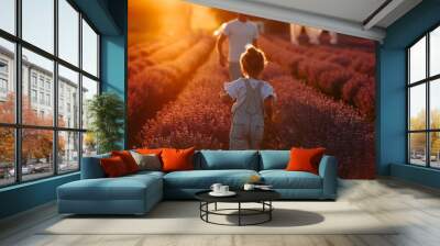 Fathers day. Young dad and toddler child daughter are having fun in a lavender field in full bloom on sunset light . Family day concept. Happy childhood, lifestyle. Wall mural