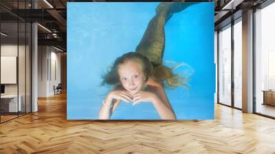 Young beautiful mermaid looks at a starfish and smiling underwater in swimming pool. underwater girls pictures Wall mural