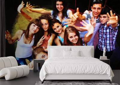 A group of young people dancing at a disco. Wall mural