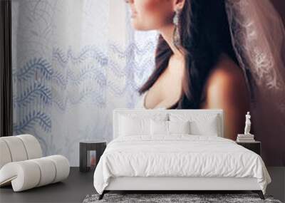 Beautiful bride in white wedding dress standing in her bedroom n Wall mural