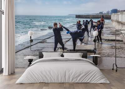 Children training karate on the stone coast Wall mural