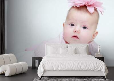 Portrait of a baby girl with a flower on her head on a white bac Wall mural