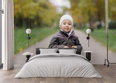 Mom and son walking and having fun together in the autumn park. Wall mural