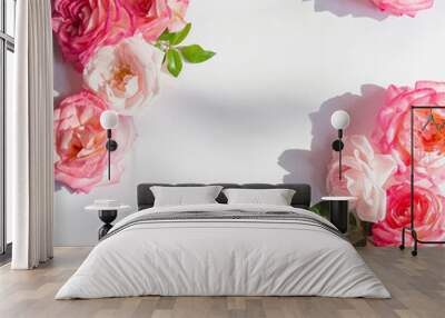 Floral composition made of beautiful pink rose buds lying as a frame on white background. Nature concept. Summer theme. Minimal style. Top view. Flat lay Wall mural