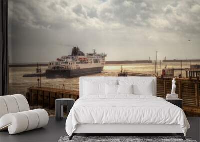 Maneuvering ferry at Dover wharf in stormy weather. A breakwater in the background. Wall mural