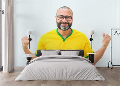 Brazilian soccer fan celebrating on white background Wall mural