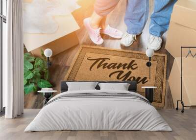 Man and Woman Unpacking Near Thank You Welcome Mat, Moving Boxes and Plant Wall mural