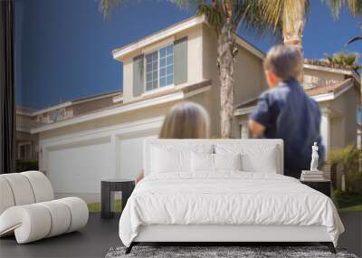 Mixed Race Young Family Looking At Beautiful Home Wall mural