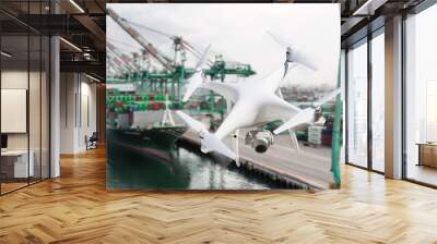 Unmanned Aircraft System Quadcopter Drone In The Air Near Large Shipping Vessel and Dock with Crates Wall mural