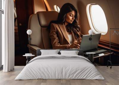 Young Adult Affluent Indian Woman Sitting and Working on Her Computer Laptop In Her Private Executive Jet - Generative Ai. Wall mural