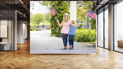 Young Sister and Brother Waving American Flags At The Park Wall mural