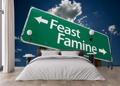 “Feast or Famine” Road Sign with dramatic clouds and sky Wall mural