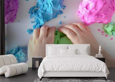 Colorful molded plasticine and childrens hands clay isolated on white background Wall mural