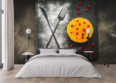 Dessert or cake made from autumn berries, sea buckthorn and lingonberries on cottage cheese cream and chocolate base. Bright yellow, afflicted with red berries on a black background. Wall mural