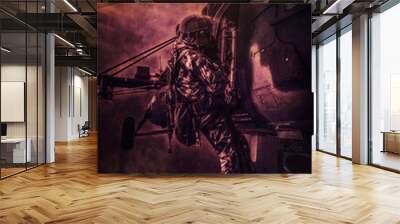 Image of a military man attached with a rope to a helicopter. Battlefield style. The concept of war and political instability. Wall mural