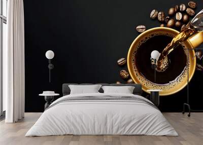 Coffee being poured into a golden cup with coffee beans on a black background. Wall mural