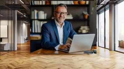 Portrait of handsome middle aged business man with laptop working in office Wall mural