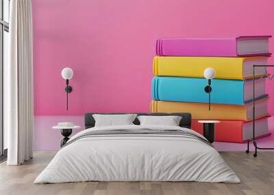 Stack of colorful books on a pink background, with copy space. Wall mural