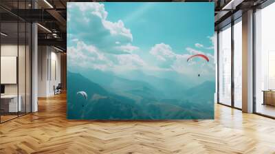 Aerial view of paragliders flying high above majestic mountain ranges Wall mural