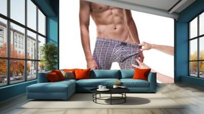 Two hands of woman stripping male boxers from right Wall mural