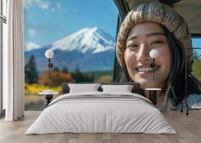 A happy woman at window car on summer road trip to Fuji mountain, Japan. Wall mural