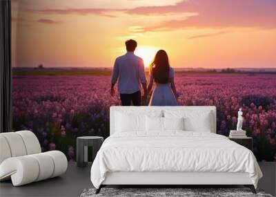 romantic flower field with blooming flowers and romantic couple at background. silhouette picture. Wall mural