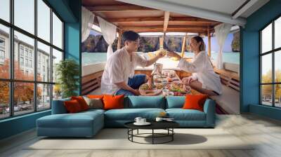 Asian couple lover travel and relax in they honeymoon trip on the wooded boat Wall mural