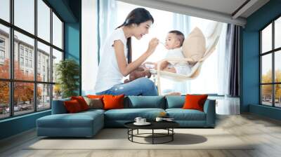 Asian mother feeding to her baby Wall mural