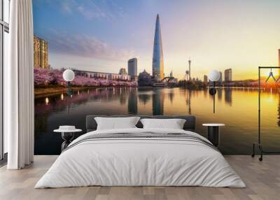 Sunrise over cherry blossom park and tower background Wall mural