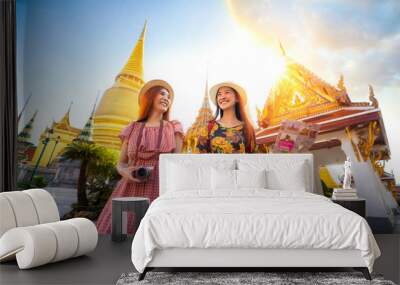 Two asian girlfriends traveling and check location by a map in Grand Palace Wall mural