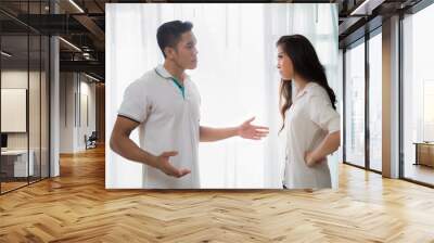 young man quarreling with his wife at home while screaming and s Wall mural