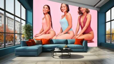 Diversity, bikini and portrait of happy women in studio, sitting together with smile and fun body positivity. Beauty, summer fashion and swimwear models with self love, equality and pink background. Wall mural