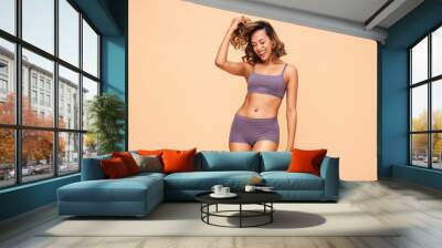 Healthy body, dance and happy woman in lingerie in studio with self love, results and skincare on wall background. Beauty, cosmetics and female model dancing for wellness, good mood or acceptance Wall mural