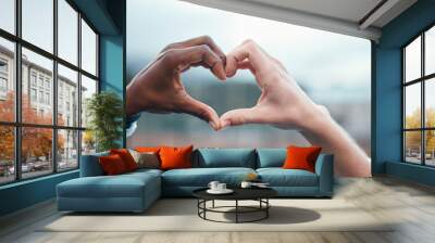 Outdoor, closeup and people with heart sign, hands and support with kindness, emoji and commitment. Outside, couple or interracial with symbol for love, trust and partnership with care, icon and like Wall mural